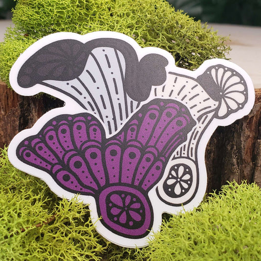 Sticker of purple, cream, gray, and black lobster mushrooms with stark black line art reminiscent of henna tattoo art. the sticker is sitting on moss and wood with ivy leaves in the background